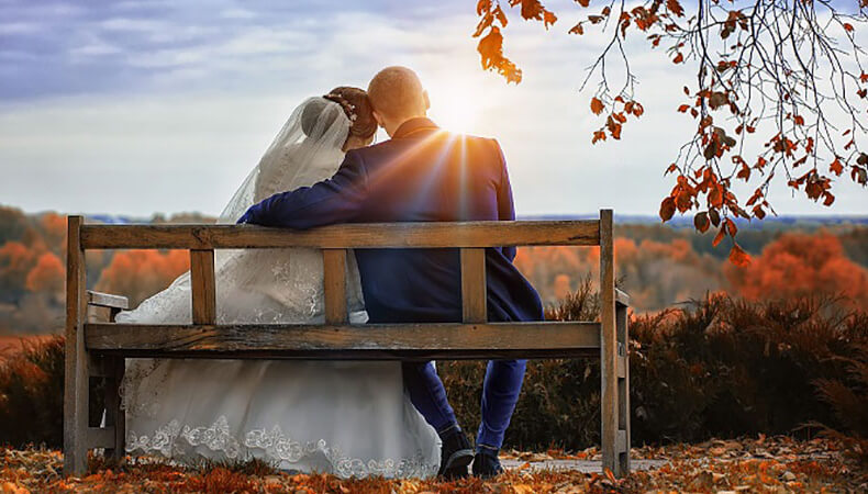 Couple seating on bench after successful marriage