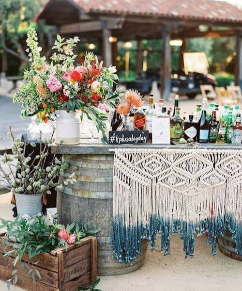 Beautiful backdrop with vibrant flowers and lots of macramé
