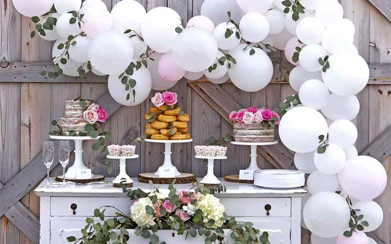 Decorate the wedding reception dessert table with balloons