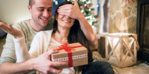 Husband giving gift to her wife