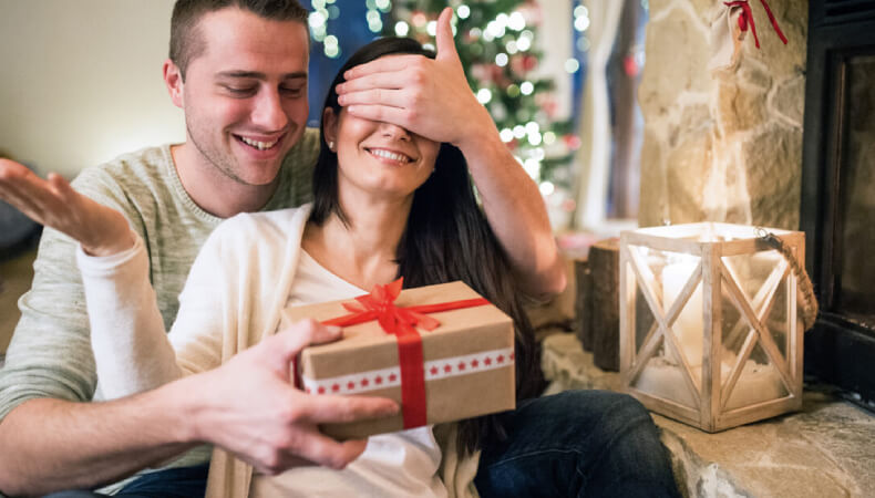 Husband giving gift to her wife