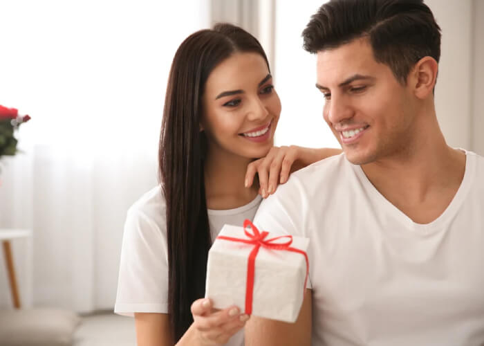 Wife giving gift to his husband