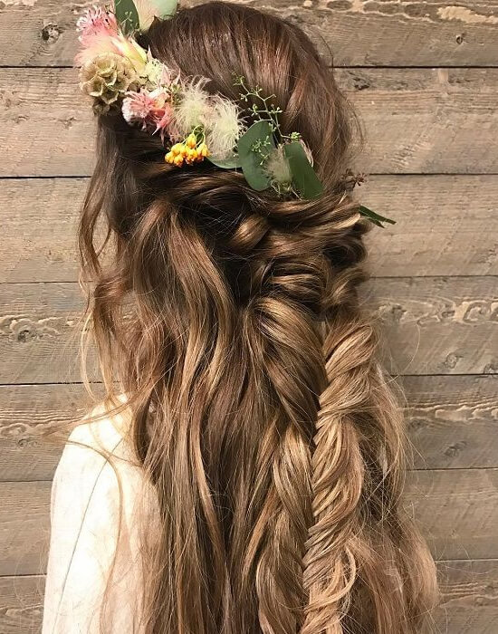 Half-up braided hairstyle with wildflowers