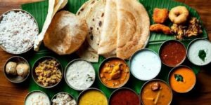Traditional South Indian wedding meal served on a banana leaf.
