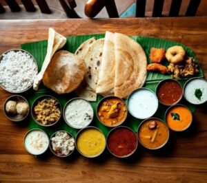 Traditional South Indian wedding meal served on a banana leaf.