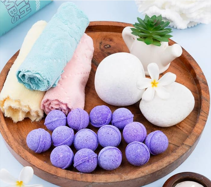Spa Set: Wooden tray with purple bath bombs and rolled towels.