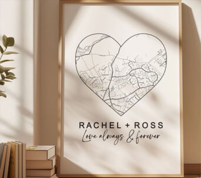 Framed wall art featuring a heart-shaped map design with the text “RACHEL + ROSS” and “always & forever” in a minimalist style.