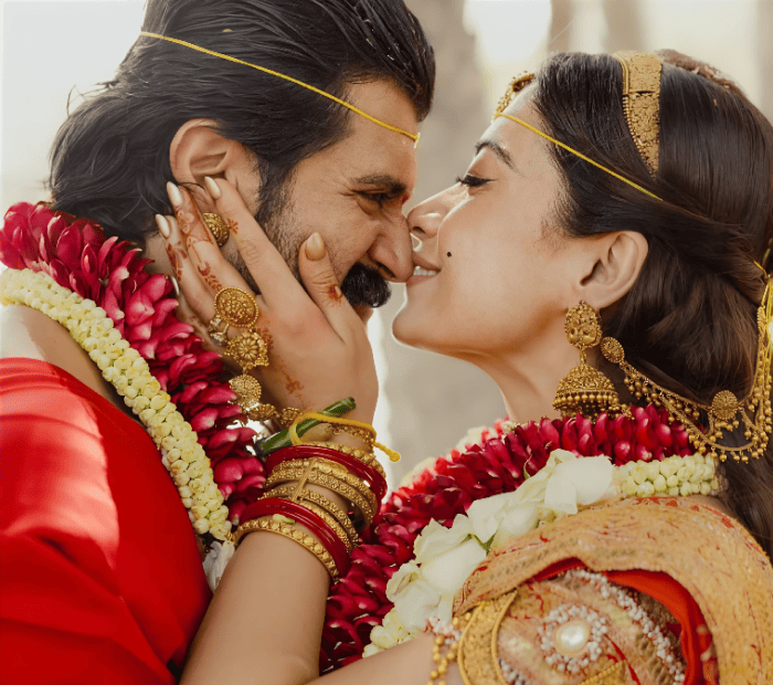 Close-up of bride and groom touching foreheads during traditional Indian wedding ceremony.