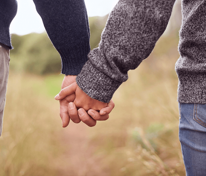 Couple holding hands during a walk outdoors