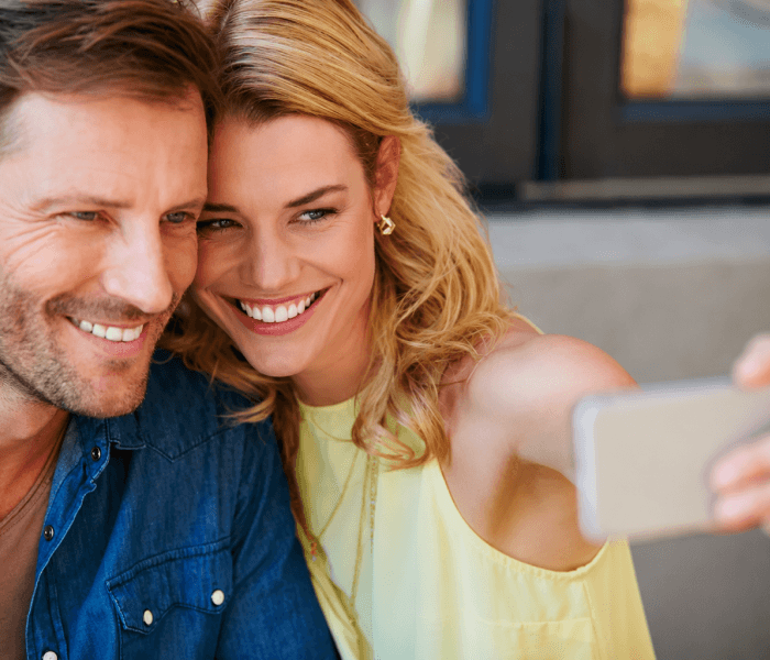 Happy couple taking a selfie togetherHappy couple taking a selfie together